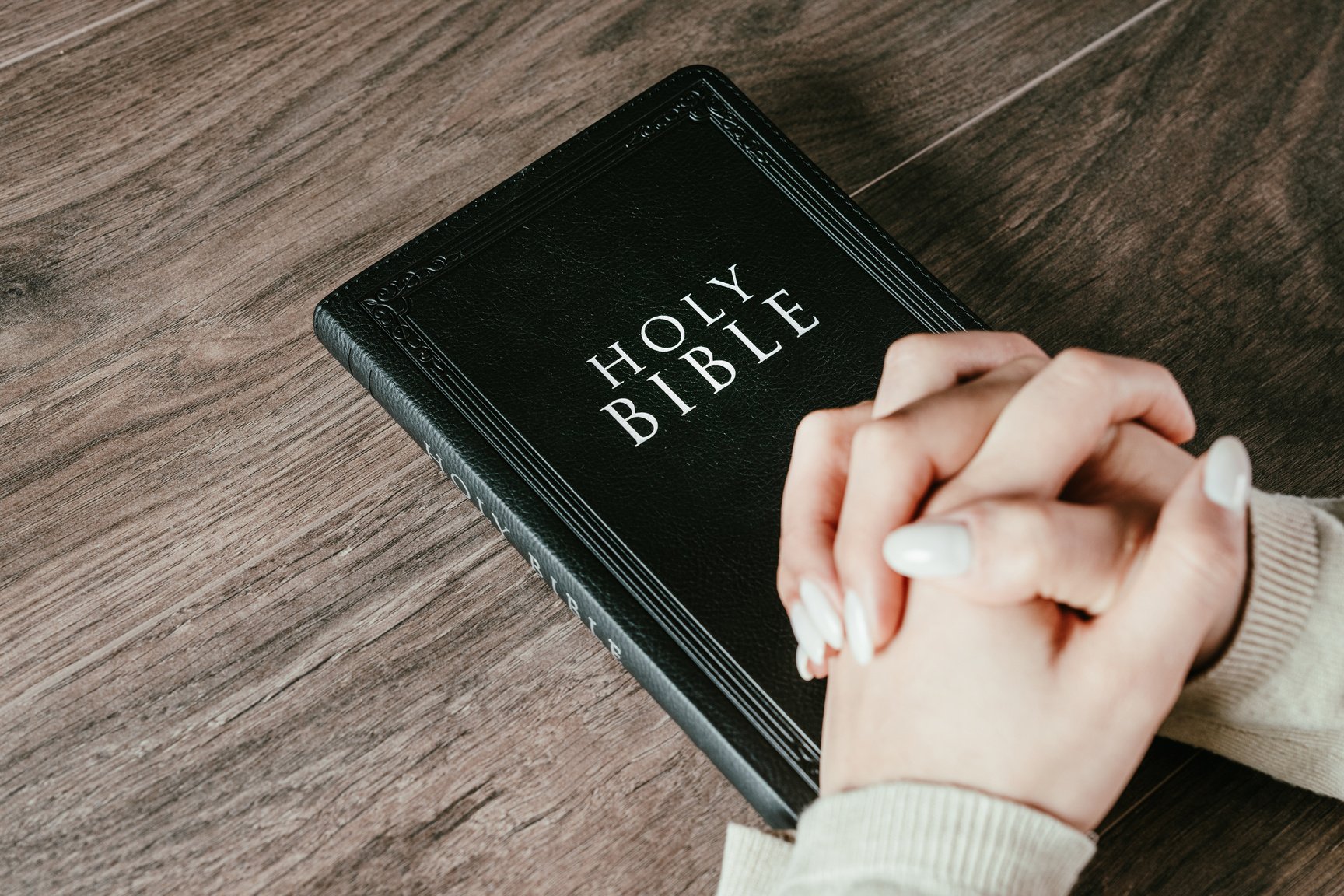 Woman praying on bible